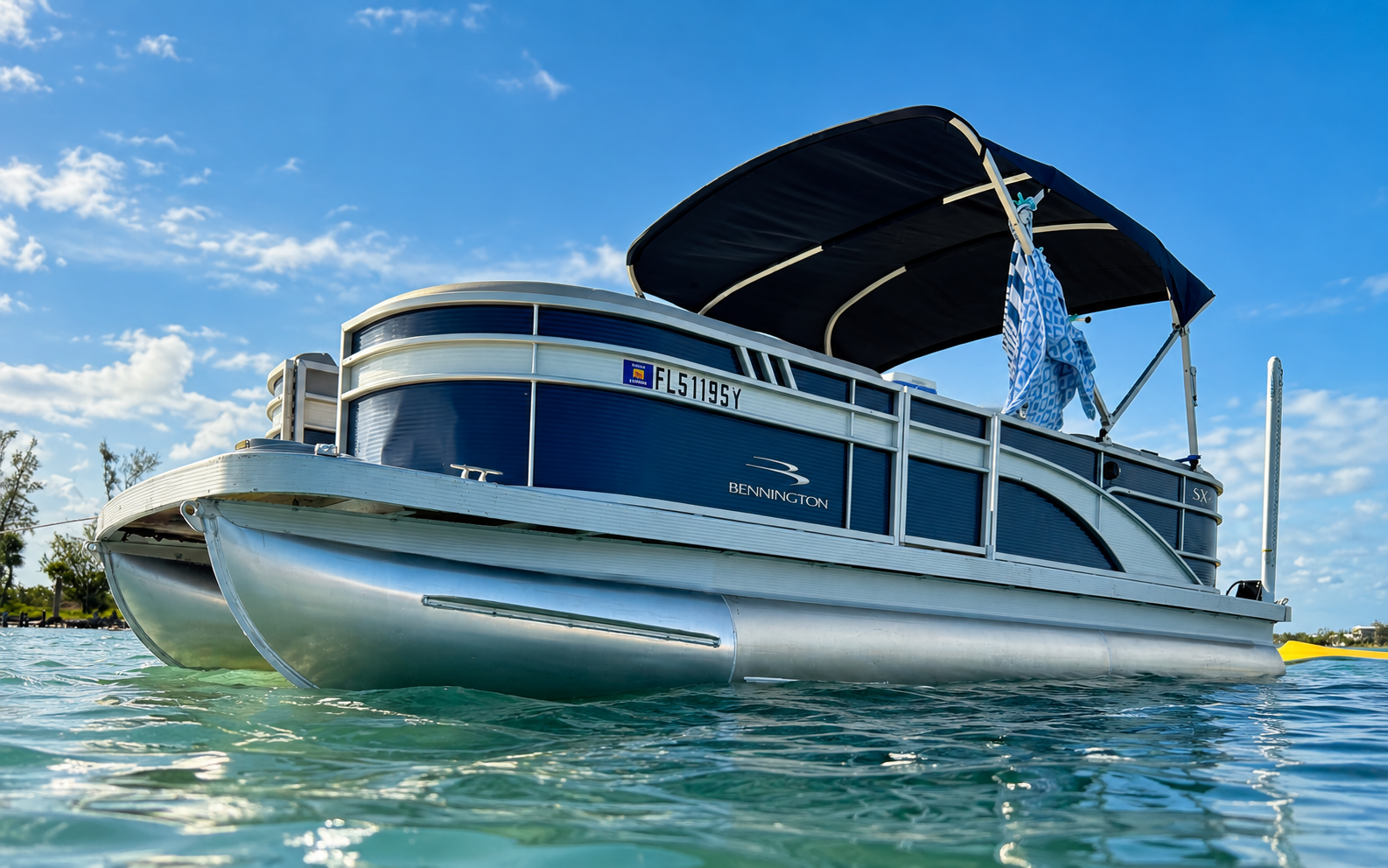 Blue Runner, a blue and silver Bennington pontoon boat on the water