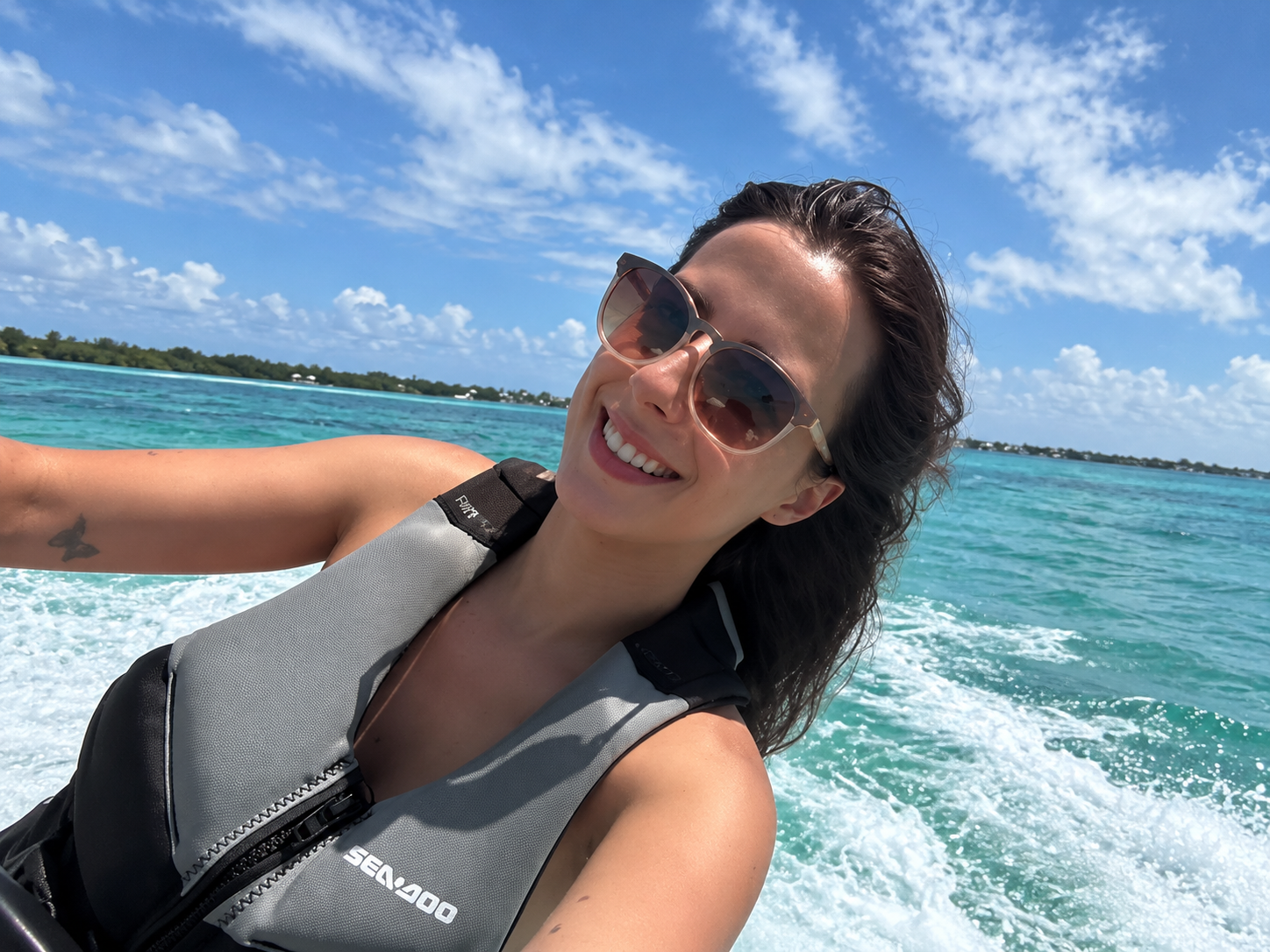 Little Philly guest smiling on the water in a life jacket