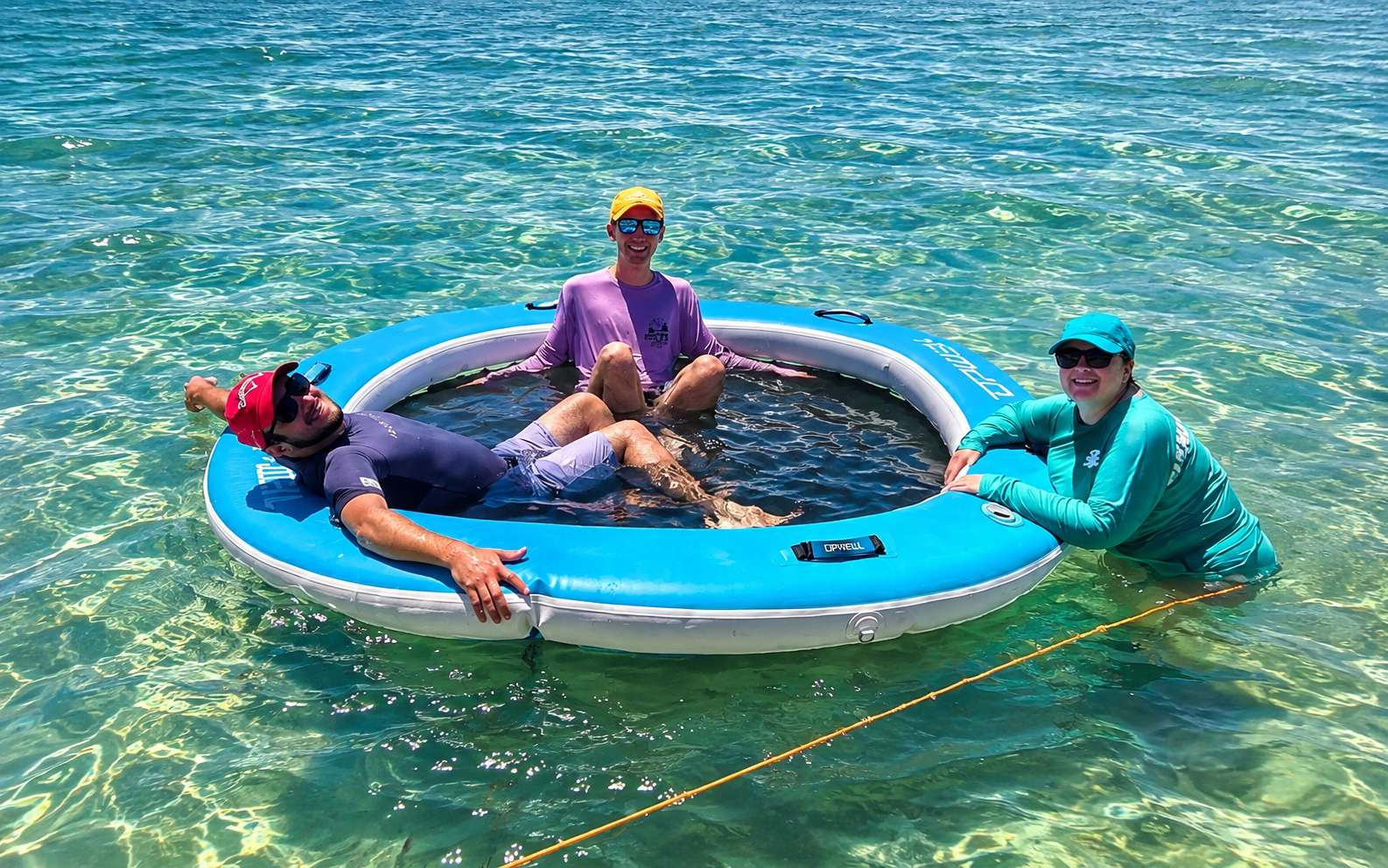 Guests relaxing together in clear water near Anna Maria Island
