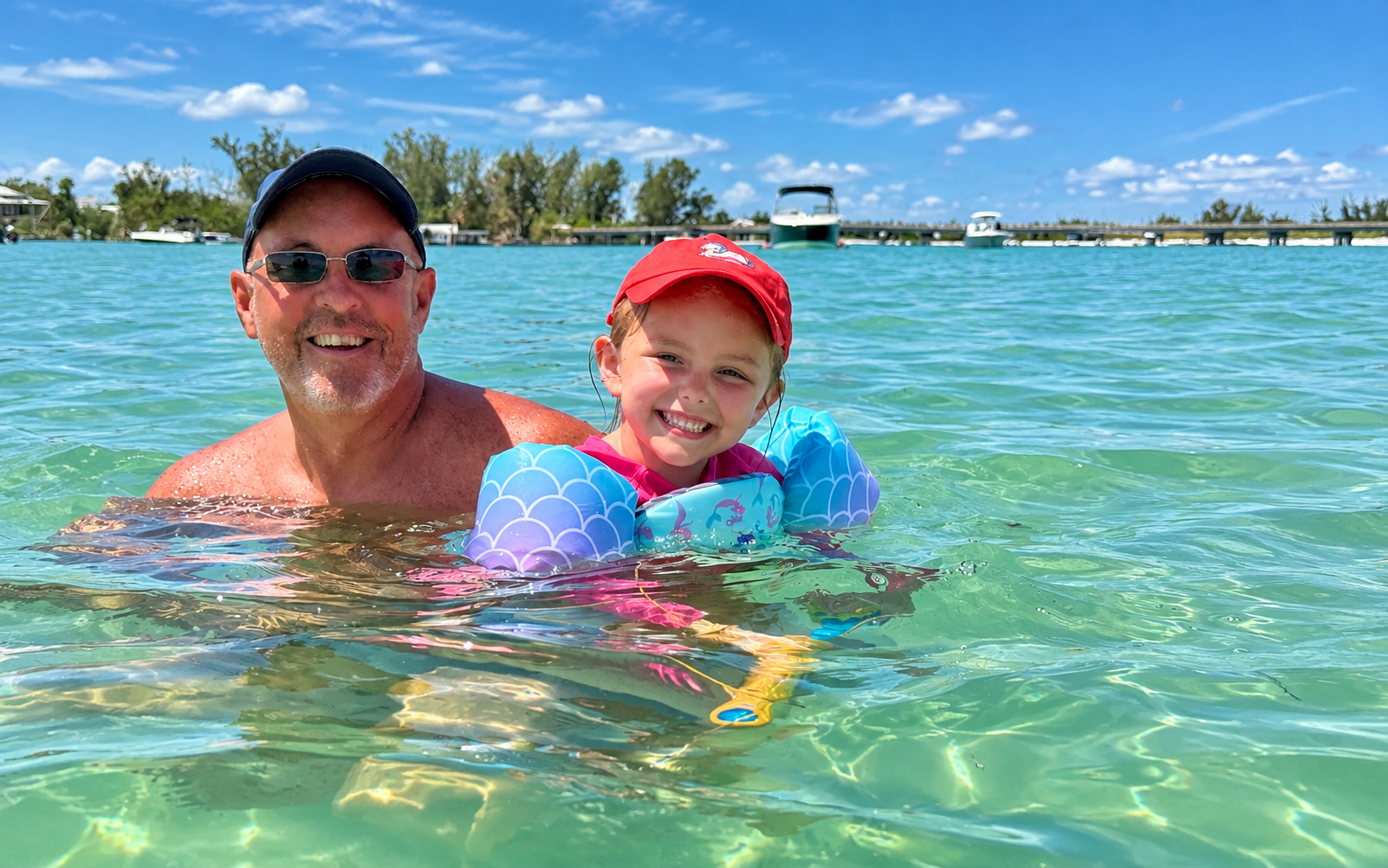 Father and daughter enjoying clear Gulf Coast water near Sarasota